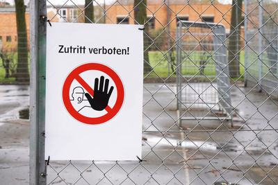 Warning sign on chainlink fence