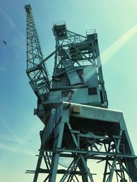 Low angle view of crane against sky