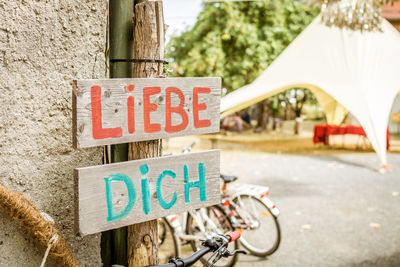 Close-up of bicycle sign on road in city