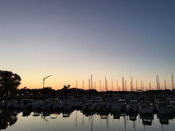 Boats in harbor at sunset