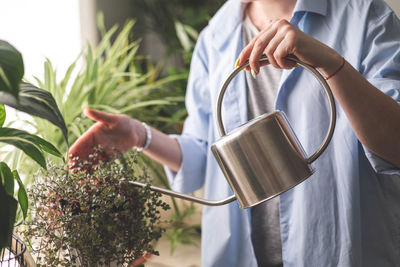 Midsection of woman holding coffee