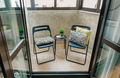 High angle view of empty chairs and table in restaurant