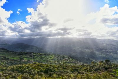 Scenic view of mountains against cloudy sky