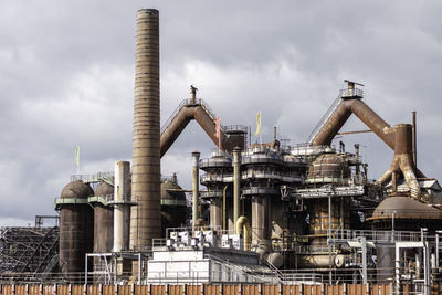 Low angle view of factory against sky