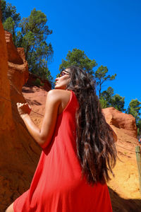 Rear view of woman standing against sky