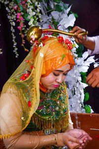 Low section of woman holding bouquet