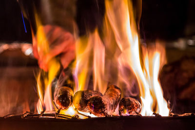 Close-up of bonfire on barbecue at night