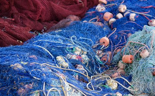 Coloured, blue fishing nets on the floor, in zanzibar. fishermen preparing for the day. 