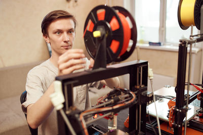 Portrait of young man holding camera