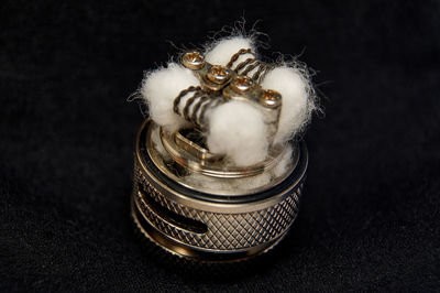 Close-up of figurine on table against black background