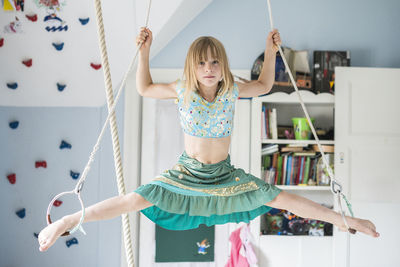 Girl doing splits while hanging  barefoot