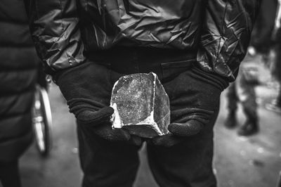 Midsection of man standing on street