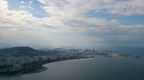 High angle view of buildings by sea against sky