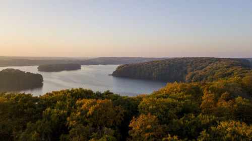 Scenic view of lake against clear sky at sunset