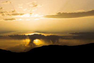 Scenic view of silhouette mountains against sky during sunset