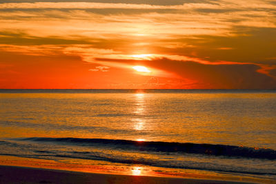 Scenic view of sea against romantic sky at sunset