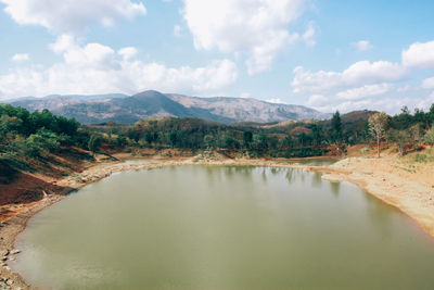 Scenic view of lake and mountains against sky