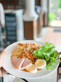 Spaghetti with pork ham and boiled egg, ready to serve