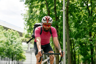 Portrait of young man riding bicycle