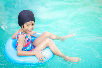 Portrait of smiling girl swimming in pool