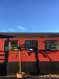 Graffiti on old train against blue sky