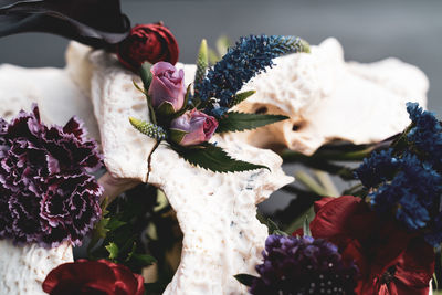 Close-up of dark bouquet and skull