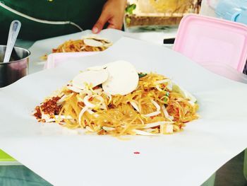 Close-up of hand in plate on table