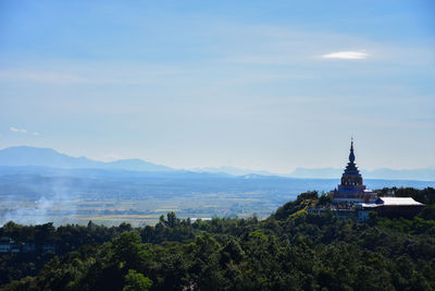 Panoramic view of trees and buildings against sky