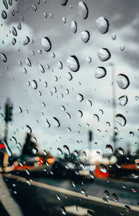 Raindrops on glass window of rainy season