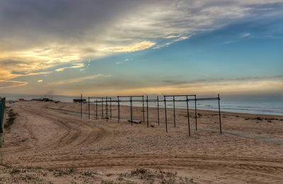 Scenic view of beach against sky during sunrise