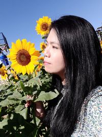 Full length of woman against sunflower