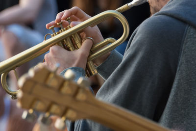 Close-up of person holding musical instrument