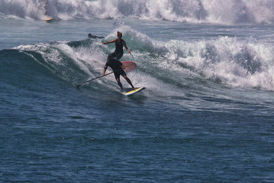 Men surfing in sea