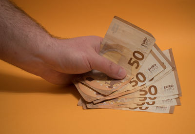 Close-up of hand holding paper