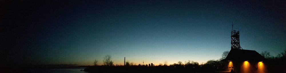 Silhouette trees against sky at night