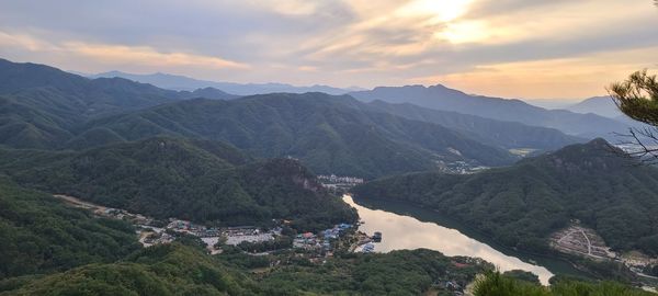 High angle view of townscape by mountains against sky