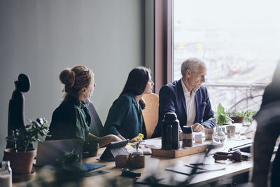 Business colleagues planning strategy during meeting in board room at office