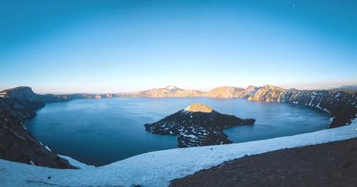 Scenic view of snow covered mountain against blue sky