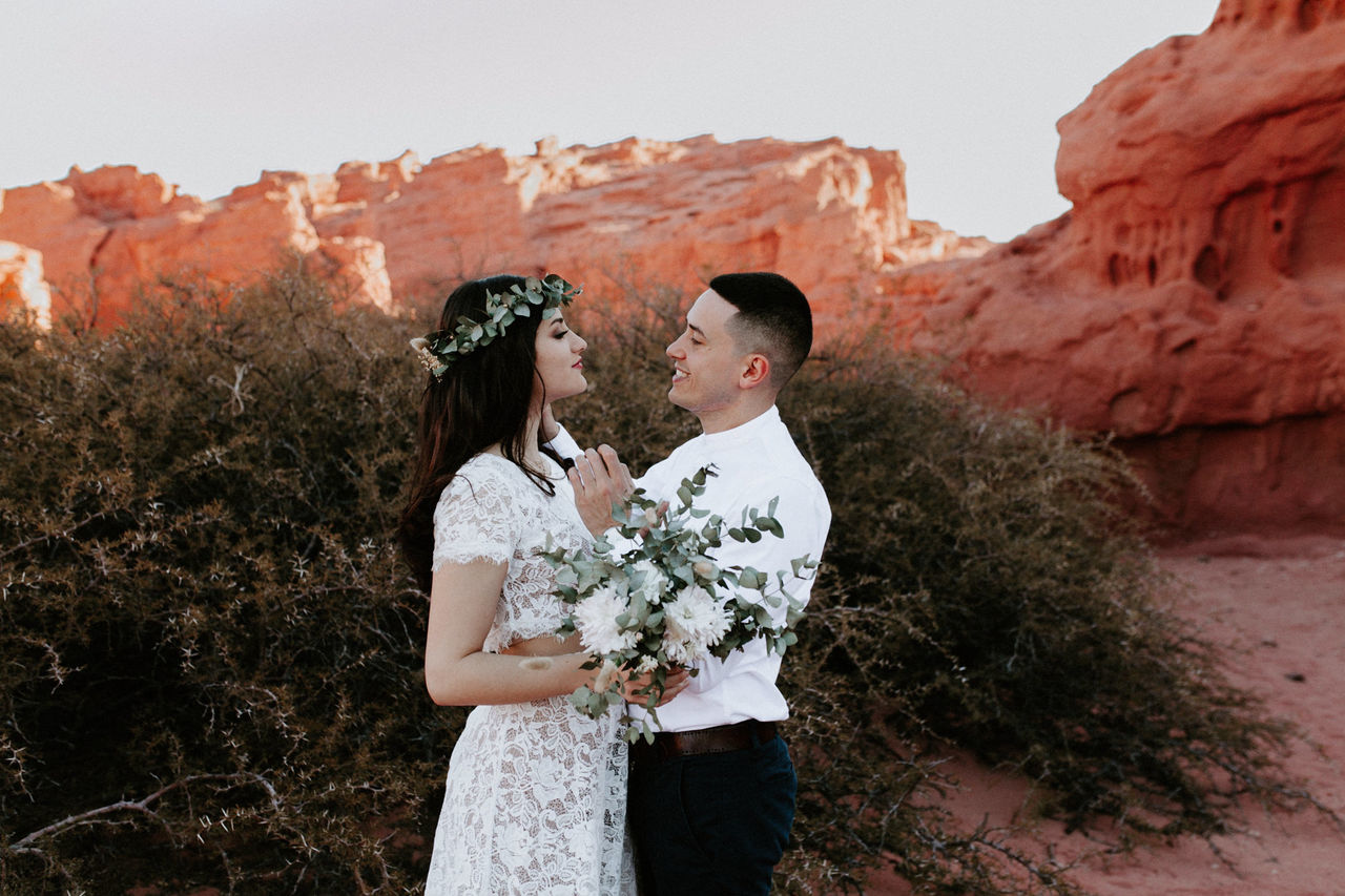 COUPLE STANDING ON ROCK