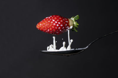 Close-up of strawberry over black background