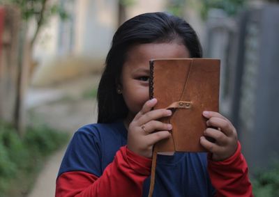 Portrait of boy holding mannequin