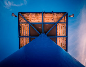 Close-up of wooden structure against blue sky