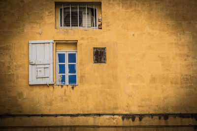 Low angle view of yellow window on building