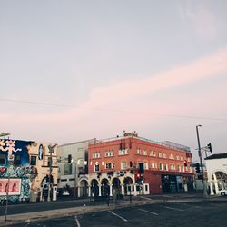 Street amidst buildings in town against sky