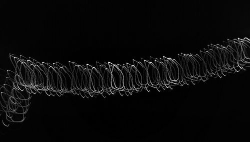 Close-up of illuminated lights over black background