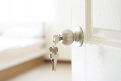 Close-up of keys hanging from doorknob