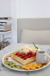 Close-up of strawberry waffle on table