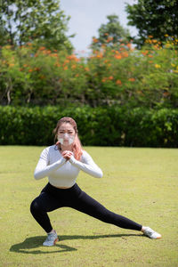 Beautiful chinese girl wearing n95 face mask while working out