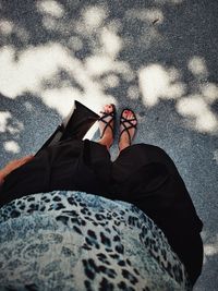 Low section of woman standing on road