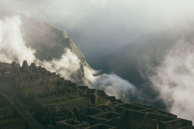 Scenic view of mountain against cloudy sky